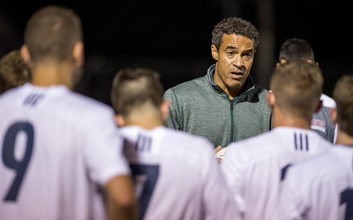 Soccer coach, Nate Houser, talking with his players