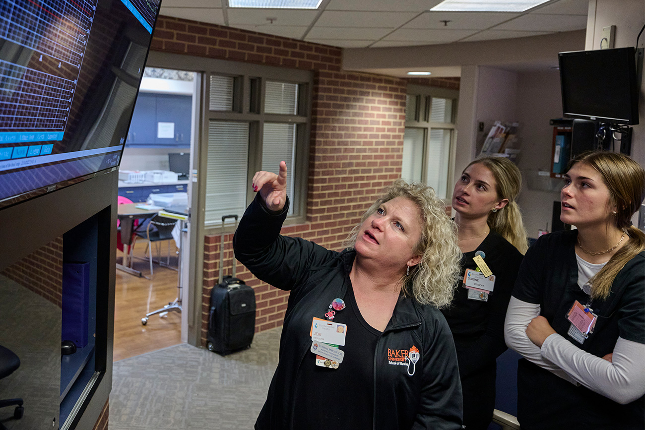 Nursing students with faculty in the mother/baby unit of the hospital.