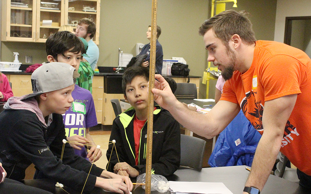 Baker student demonstrating science project to fifth graders in the lab