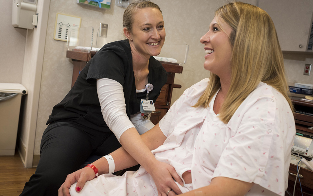 Nursing student feeling the stomach of patient