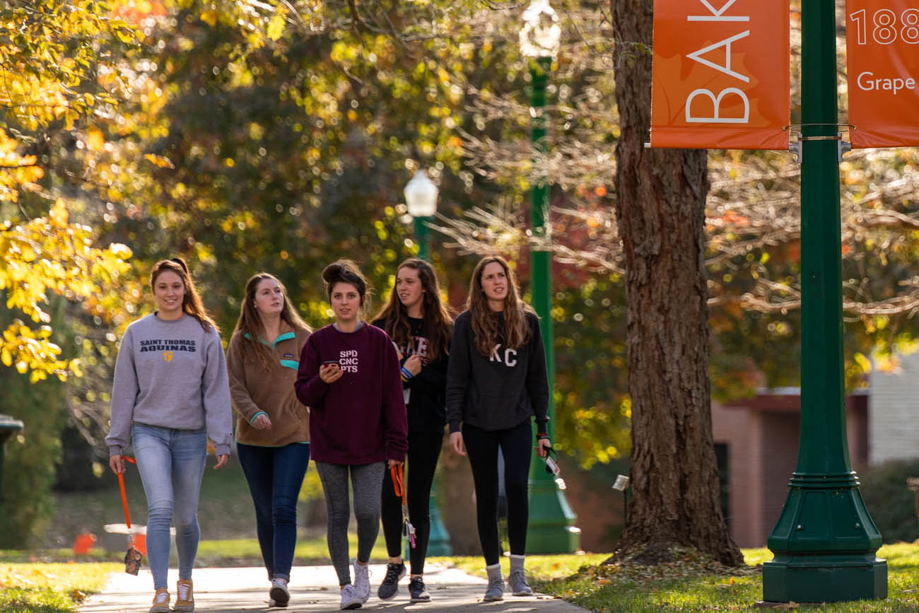 Five girls walking on campus