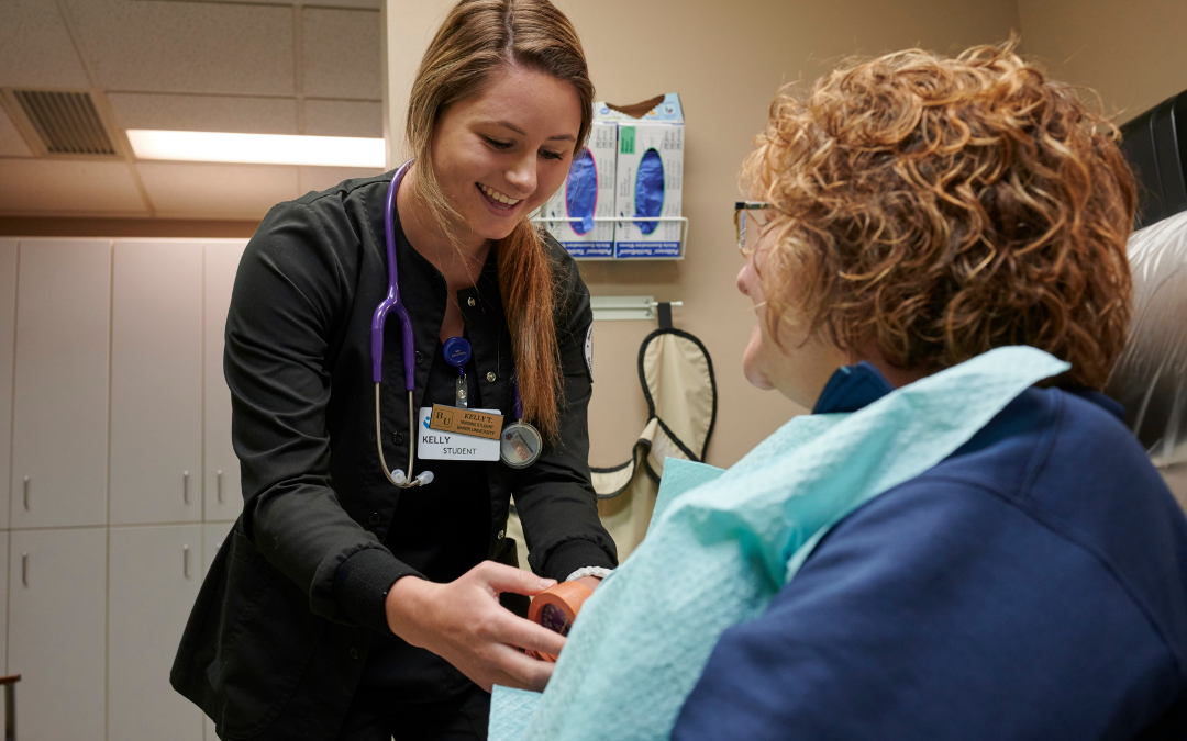 Nursing student taking vitals of dental patient