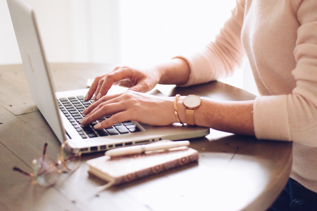 Woman typing on laptop keyboard