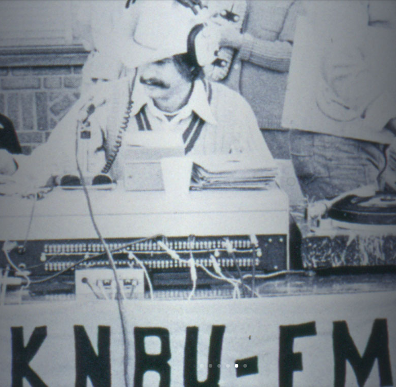 black and white photo from the archives mission of a man using a sound board