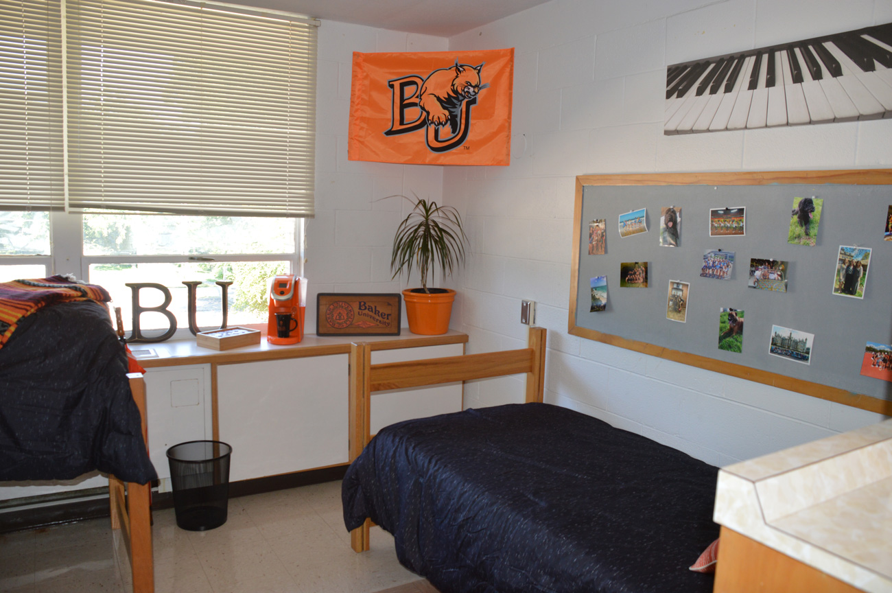 Photo of Irwin and Gessner dorm room, bed and bulletin board depicted