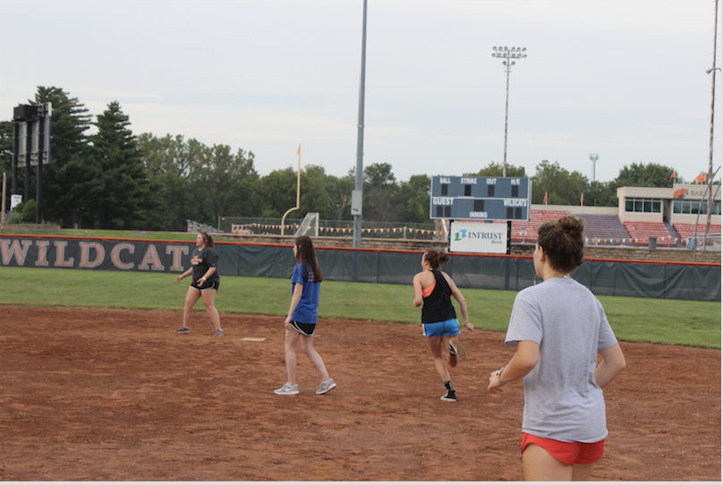 Students playing recreational softball on the softball field