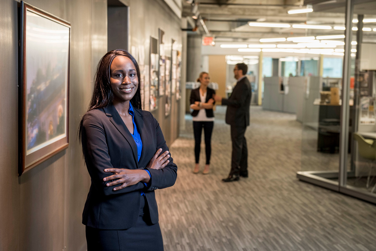 professional business woman smiling and posing with crossed arms for photo