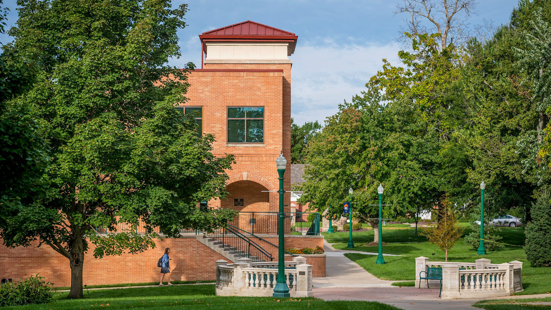 Female student walking outside of Collins library