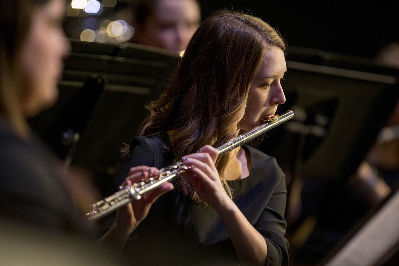 Female student playing the flute during a band concert