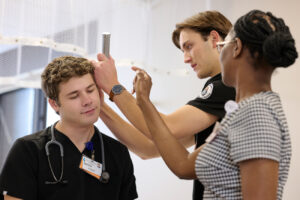 student nurses checking a patient's ear