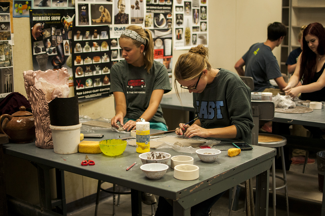 Students making clay creations in Baker art club meeting