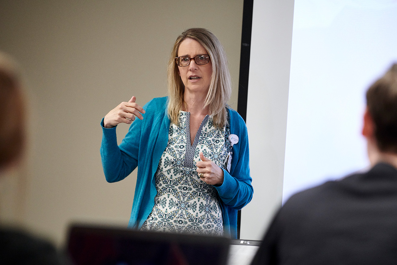 Nursing professor giving a lecture to students in a classroom