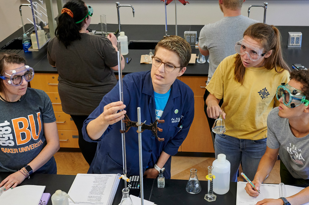 Instructor and students around equipment in the chemistry labry b