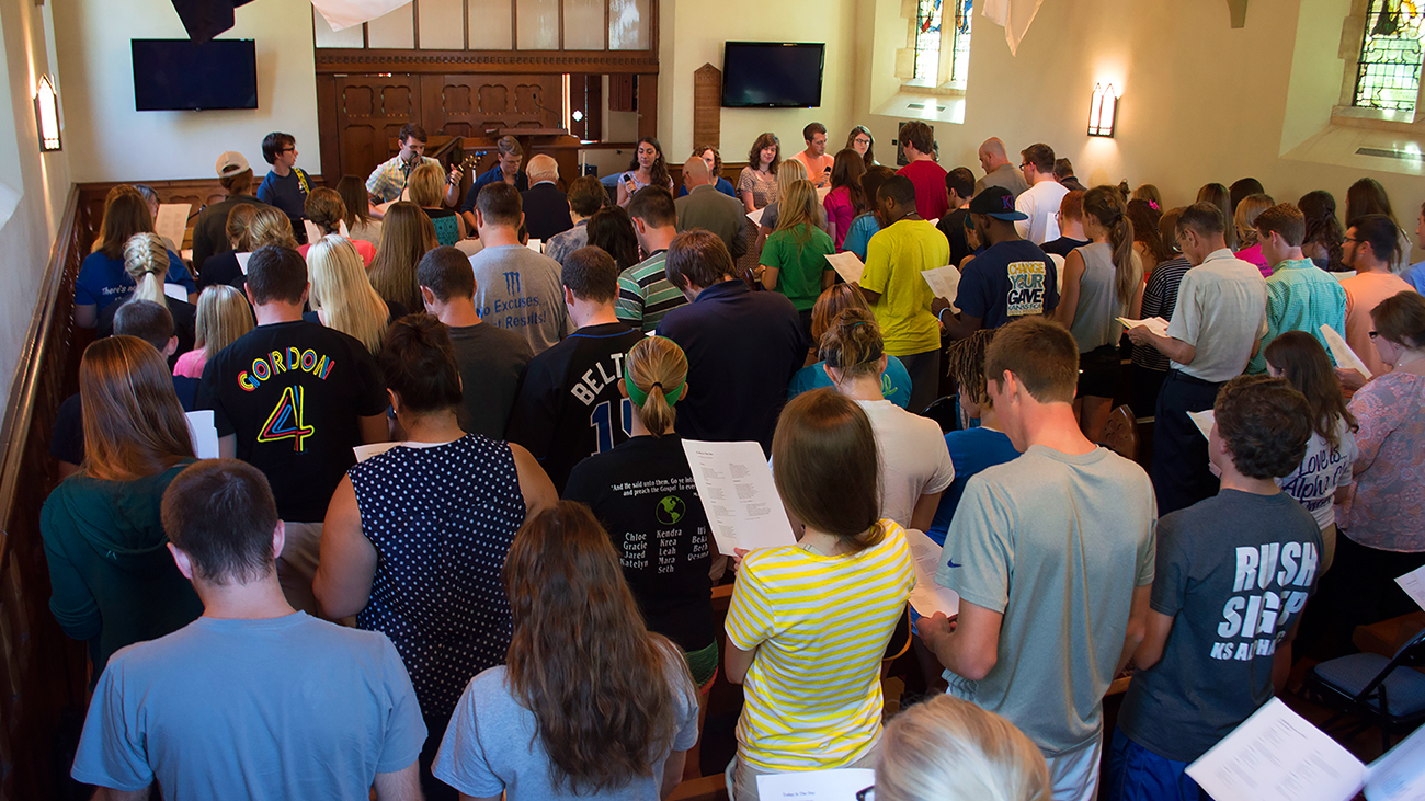 Crowd of students singing in chapel