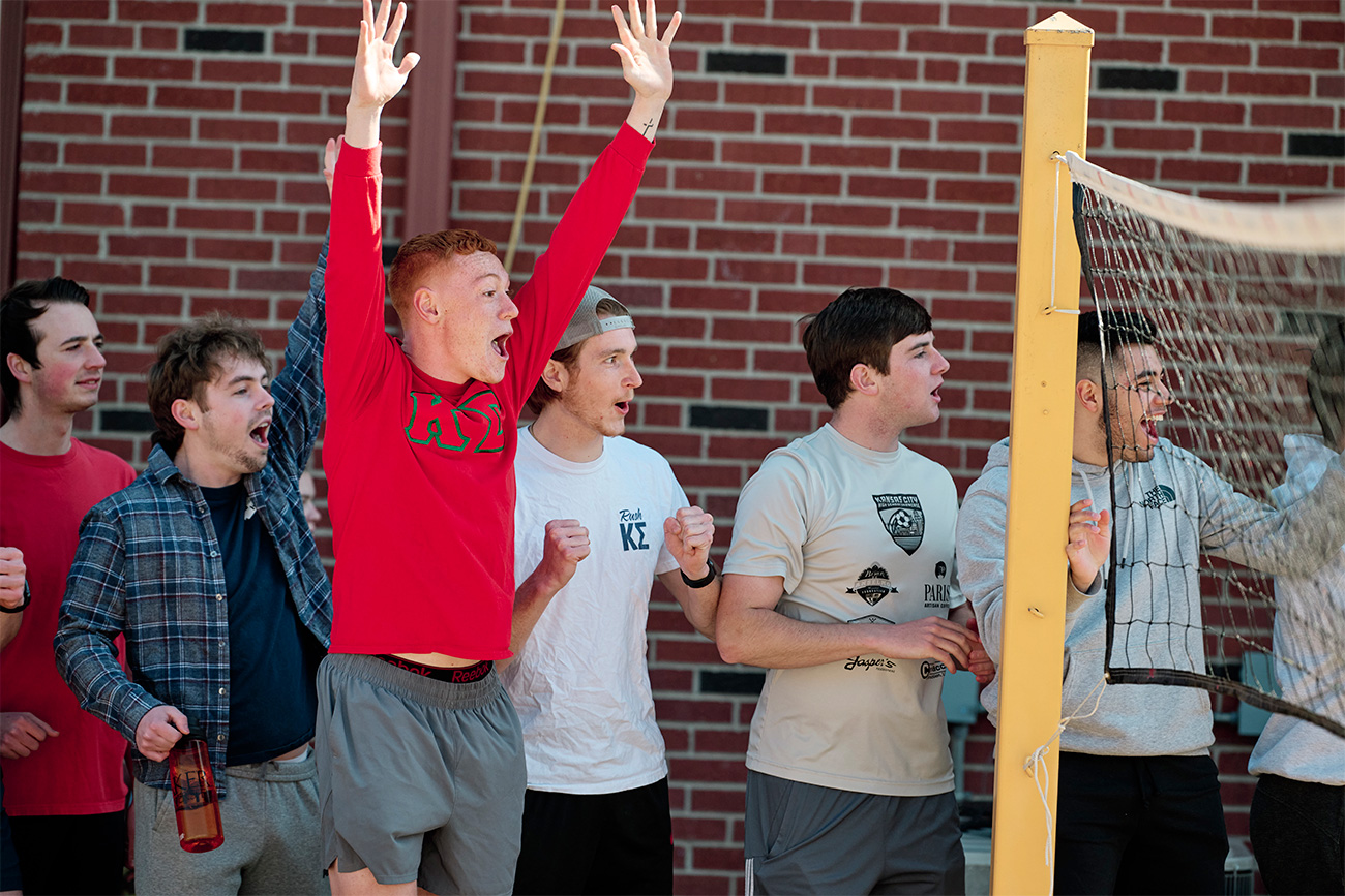 Fraternity men cheering on their friends.