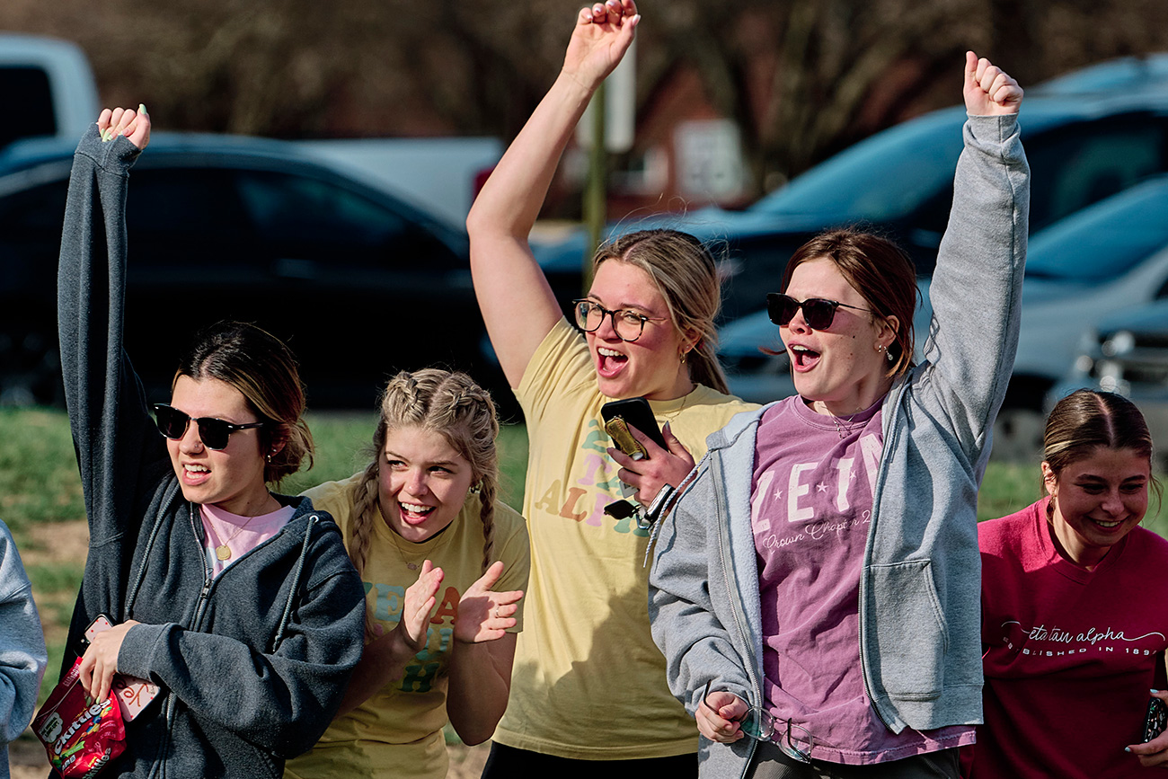 Sorority sisters cheering on their friends.