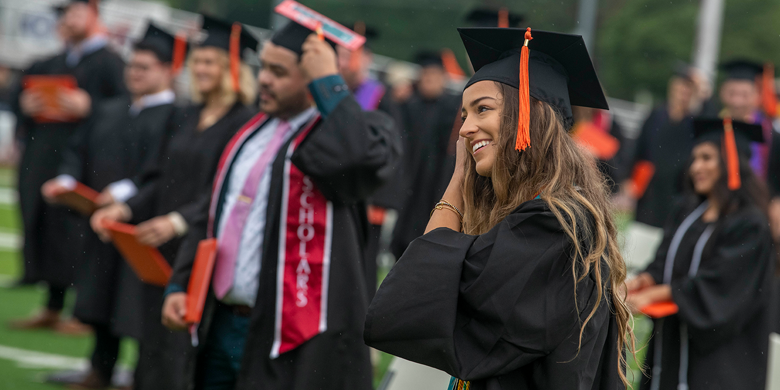 Graduates at outdoor commencement ceremony