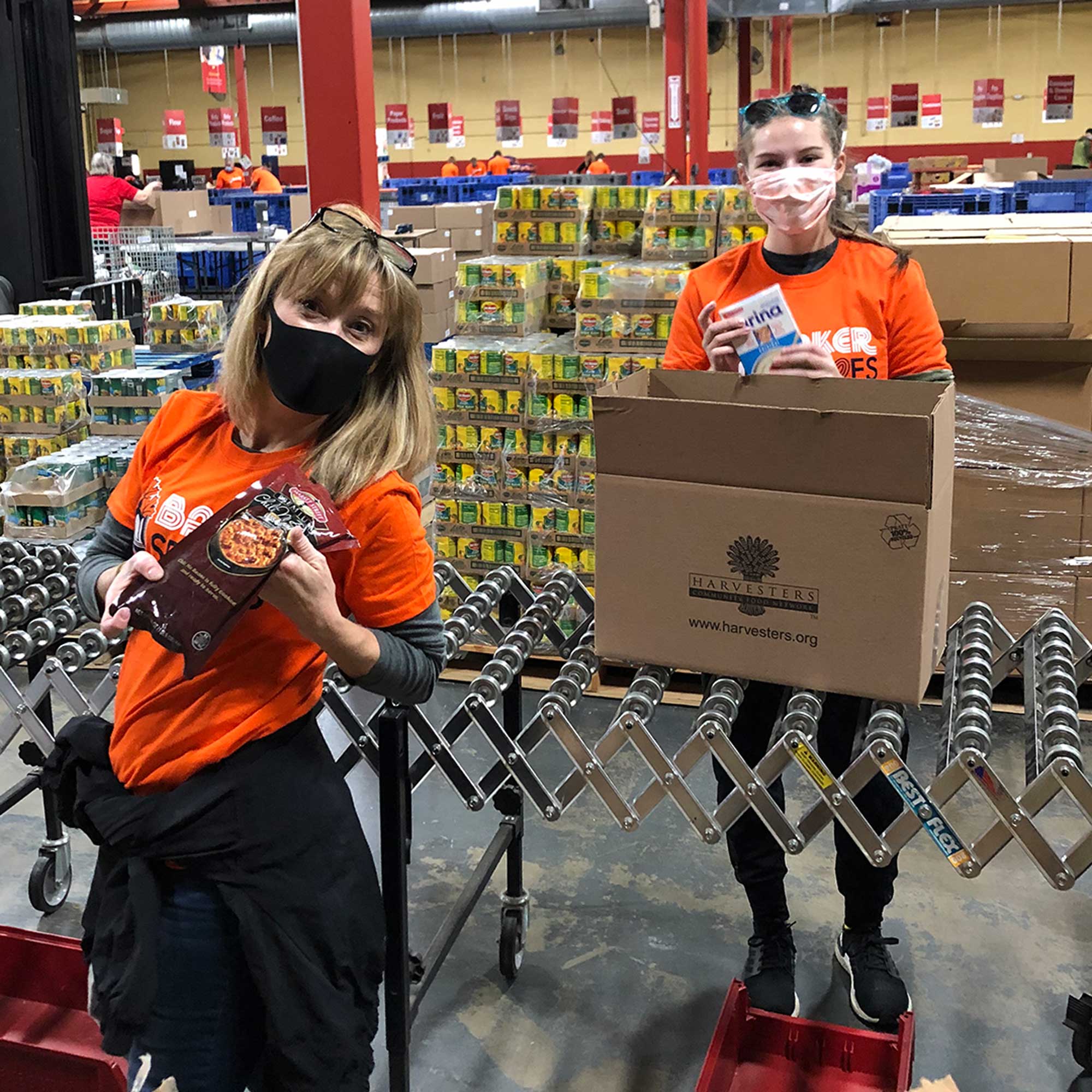 Two women volunteering at Harvesters