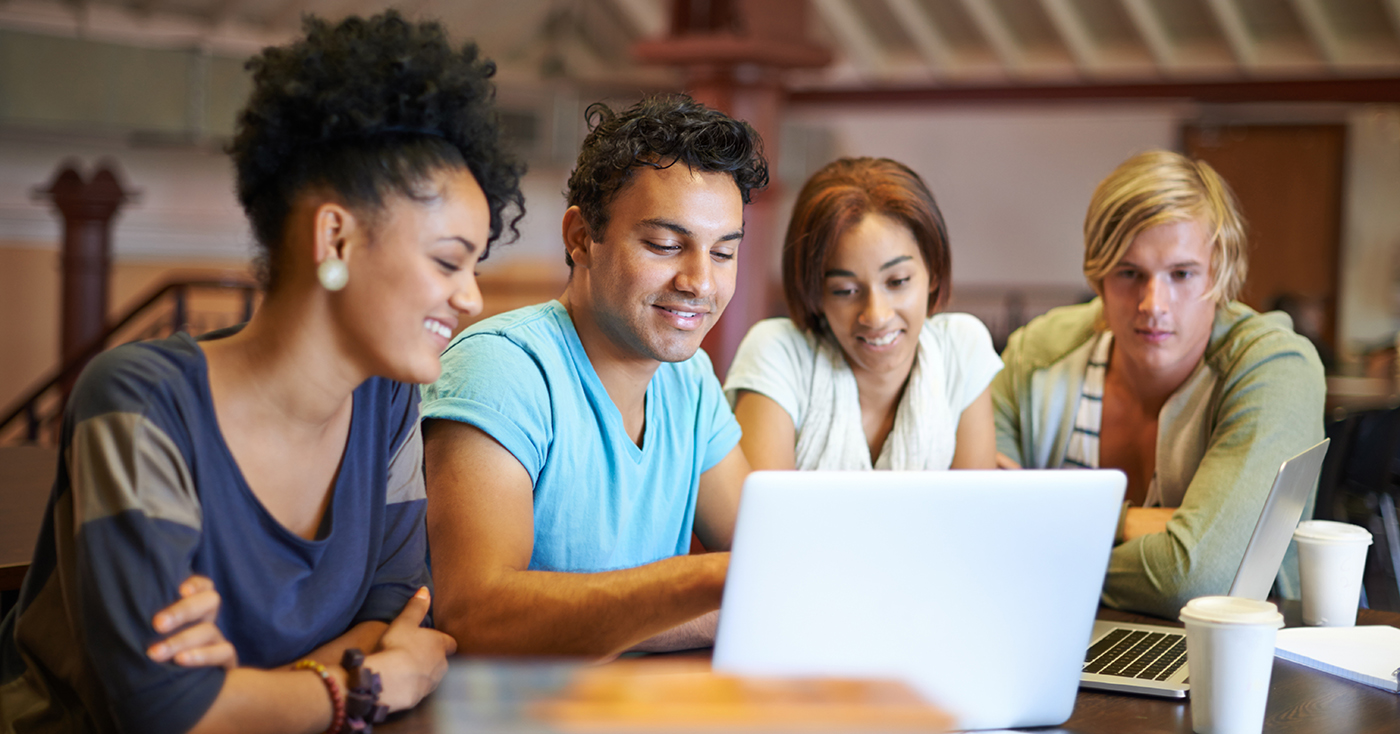 students in front of a laptop